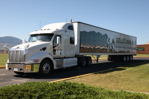 Semi truck with 'Highlands College' branding.